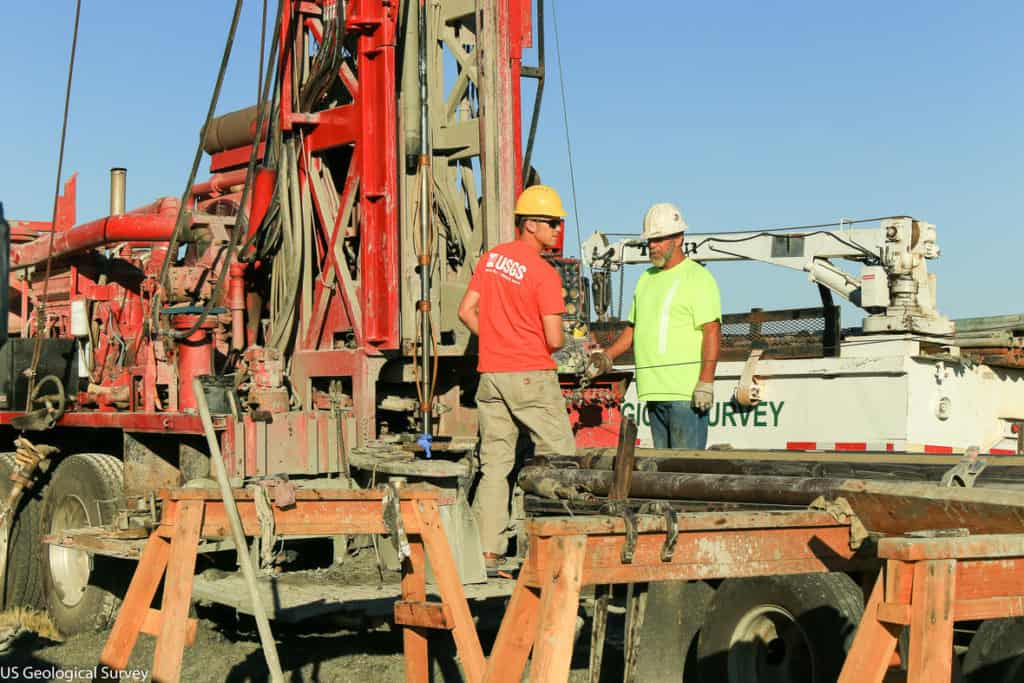 USGS scientists drilling a well